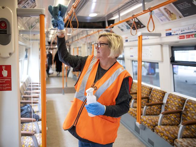 A Transport For London worker cleans hand rails on London’s the Tube. Picture: Getty Images