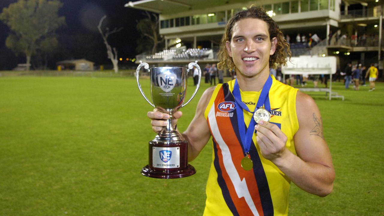 NT Thunders Captain Cameron Ilett holds his winning medal and the northeast AFL-Football Final trophy