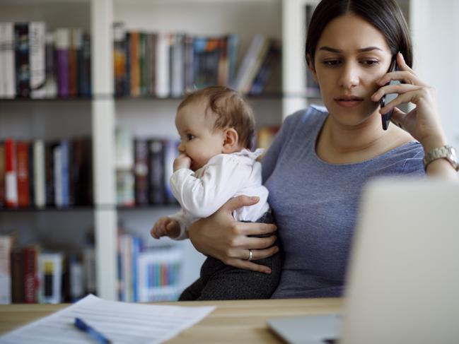 Worried mother using mobile phone an laptop at home