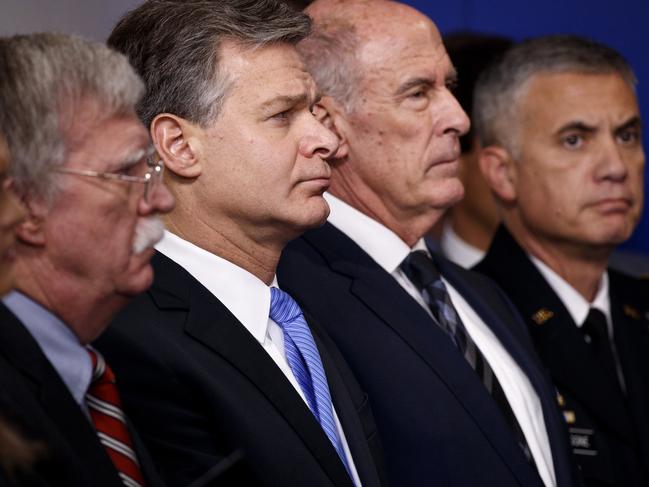 FBI Director Christopher Wray listens during the daily press briefing at the White House, Thursday, Aug. 2, 2018, in Washington. From left also listening are White House press secretary Sarah Huckabee Sanders, national security adviser John Bolton, Wray, Director of National Intelligence Dan Coats, and National Security Agency Director Gen. Paul Nakasone. (AP Photo/Evan Vucci)