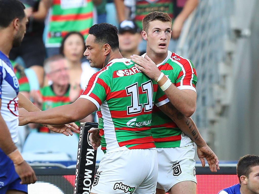Souths players celebrate the match winning try.