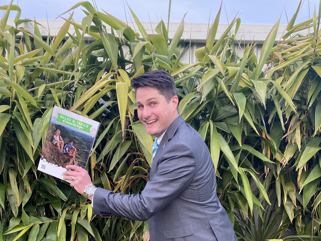 Cr Tim McMahon with a copy of the new Walks and Trails of Toowoomba Region Guide