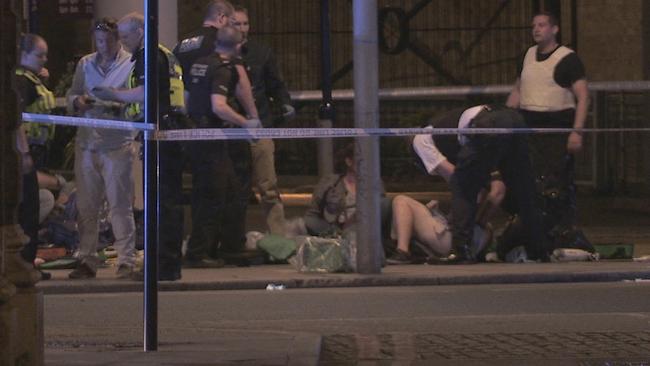 Injured people lie on the ground as paramedics treat them for injuries in Thrale Street near London Bridge, Picture: AP