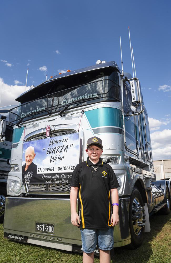 Dale Weier, 10, stands by his father's truck and memorial at Lights on the Hill Trucking Memorial at Gatton Showgrounds, Saturday, October 5, 2024. Picture: Kevin Farmer