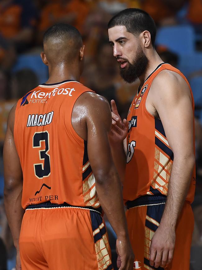 CAIRNS, AUSTRALIA – MARCH 28: Scott Machado and Jordan Ngatai of the Taipans discuss tactics during the round 11 NBL match between the Cairns Taipans and the Adelaide 36ers at Cairns Pop Up Arena on March 28, 2021 in Cairns, Australia. (Photo by Albert Perez/Getty Images)