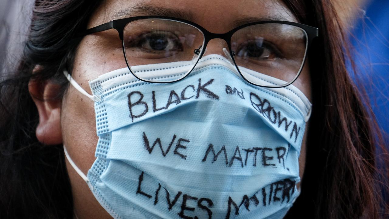 A mask with a message: a demonstrator protests the death of unarmed black man George Floyd, who died in police custody in Minneapolis in May. Picture: AP