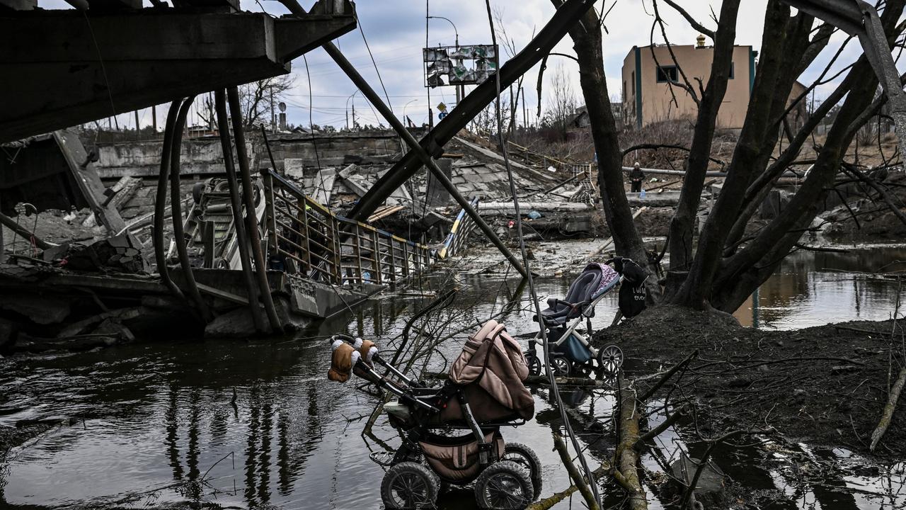 Abandoned stroller under a destroyed bridge as people flee the city of Irpin, west of Kyiv. Picture: AFP