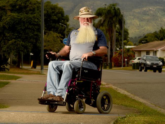 Kirwan resident Garth Brielow is frustrated that he can't get around town in his wheelchair because of cars parked on footpaths and broken pavers everywhere. Picture: Evan Morgan