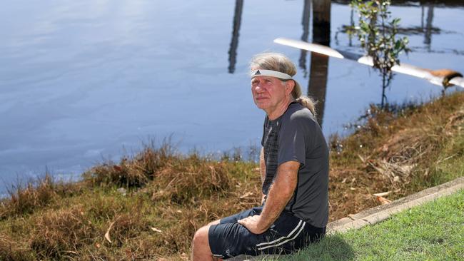 Carrara resident John Johnson at Witt Canal, which he thinks may contain oil-based pollution. Picture: Tim Marsden