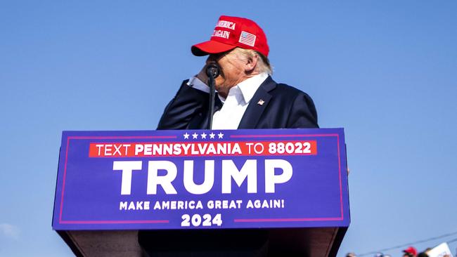 Donald Trump touches his ear after being shot. Picture: Doug Mills/The New York Times