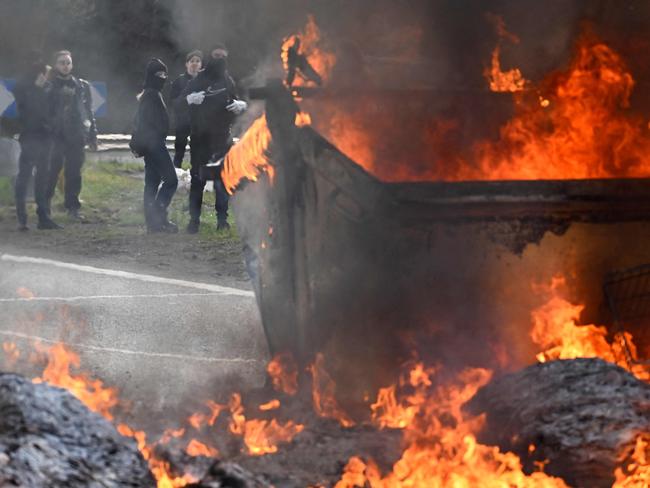 Skips burn during a protest in Rennes, northwest France on March 20, 2023, after the French government pushed a pensions reform using the article 49.3 of the constitution. - French Prime Minister Elisabeth Borne on March 20, 2023 faces two motions of no confidence in the National Assembly lower house, after forcing through an unpopular pension reform last week without a vote. (Photo by Damien MEYER / AFP)