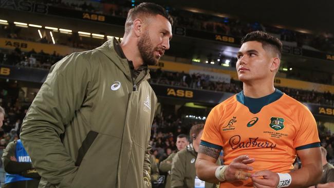 AUCKLAND, NEW ZEALAND - AUGUST 07: Noah Lolesio of the Wallabies chats with teammates Quade Cooper and Duncan Paia'Aua after the Rugby Championship and Bledisloe Cup match between the New Zealand All Blacks and the Australia Wallabies at Eden Park on August 07, 2021 in Auckland, New Zealand. (Photo by Anthony Au-Yeung/Getty Images)