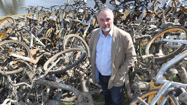 Yarra Riverkeeper Andrew Kelly with a pile of oBikes fished out of the Yarra. Picture: David Crosling