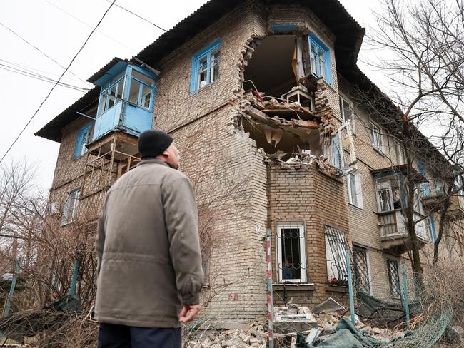 A man looks at a damaged building in Mironova Street in Donetsk after a shelling attack. Tension began to escalate in Donbass. Picture: Supplied