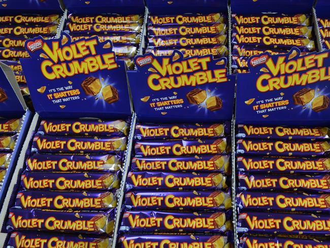 Violet Crumble chocolate bars are seen as SA Premier Jay Weatherill tours the Robern Menz factory in Adelaide, Thursday, January 11, 2018. The iconic Violet Crumble chocolate bar is back in Australian hands after an Adelaide business inked a deal with food giant Nestlé to acquire the brand. The agreement will bring 30 new jobs and a $4 million upgrade for South Australian confectionary manufacturer Robern Menz. (AAP Image/Brenton Edwards) NO ARCHIVING