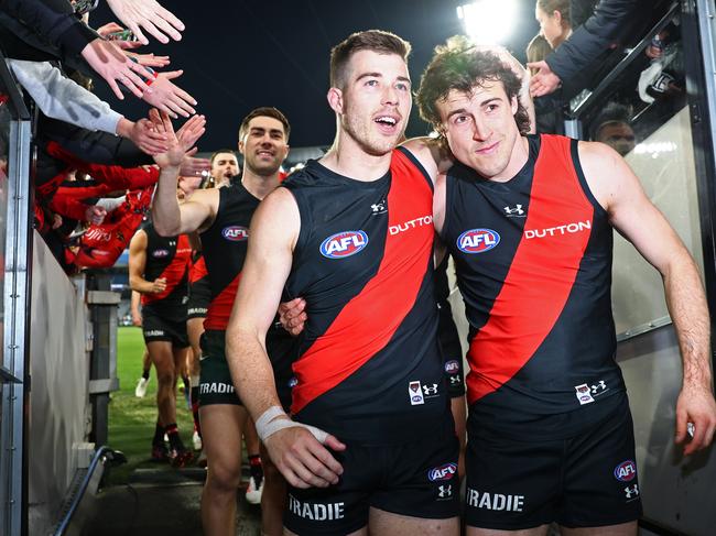 Zach Merrett and Andrew McGrath lead the Bombers off the MCG. Picture: Quinn Rooney/Getty Images