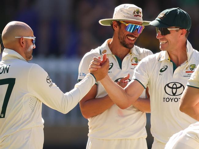PERTH, AUSTRALIA - DECEMBER 17: Pat Cummins of Australia congratulates Nathan Lyon of Australia during day four of the Men's First Test match between Australia and Pakistan at Optus Stadium on December 17, 2023 in Perth, Australia (Photo by James Worsfold - CA/Cricket Australia via Getty Images)