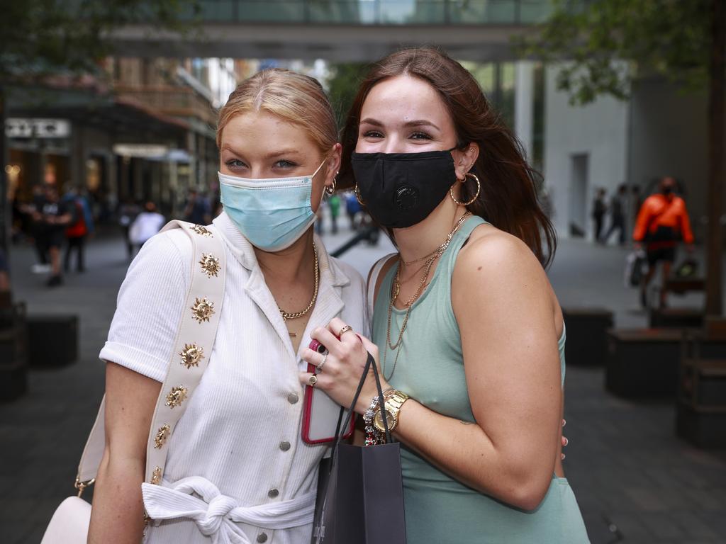 Claudia Martin and Mya Shiagetz with their masks in Pitt Street Mall, Sydney. Picture: Justin Lloyd.