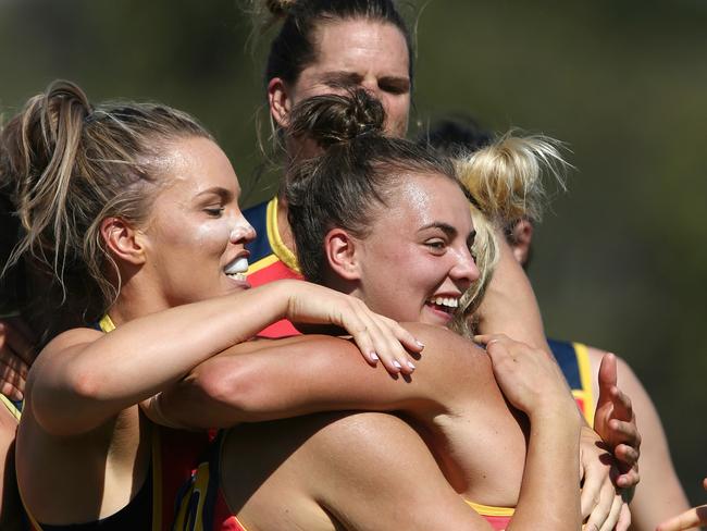 Ebony Marinoff celebrates the win with teammates. Picture: Wayne Ludbey