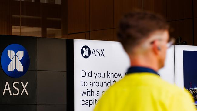 SYDNEY, AUSTRALIA - NewsWire Photos, October 29 2024. GENERIC. Stocks. Finance. Economy. A man in hi vis clothing walks past the Australian Stock Exchange, ASX, on Bridge Street. Picture: NewsWire / Max Mason-Hubers