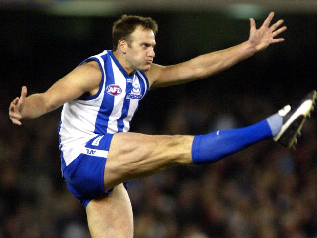 JULY 2, 2004 : Saverio Rocca kicking a goal during Essendon v North Melbourne Kangaroos AFL game at Telstra Dome in Melbourne, 02/07/04. Pic Kelly Barnes.Australian Rules A/CT