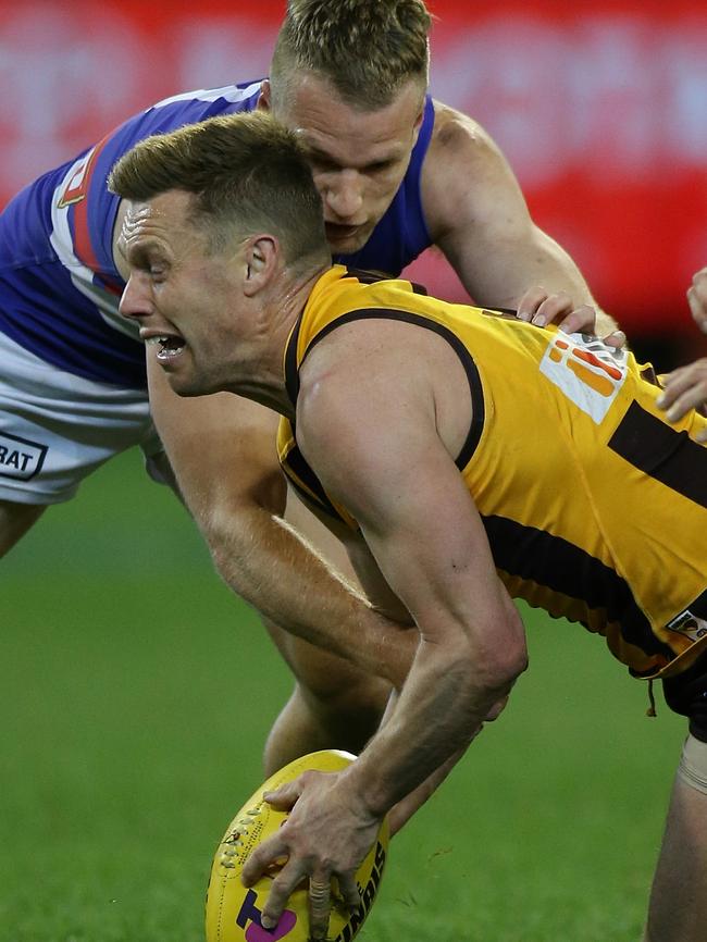 Sam Mitchell tries to gather under fierce Western Bulldogs pressure. Picture: Wayne Ludbey