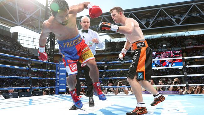 Jeff Horn and Manny Pacquiao slug it out during their WBO World Welterweight title fight at Suncorp Stadium. Picture: Peter Wallis