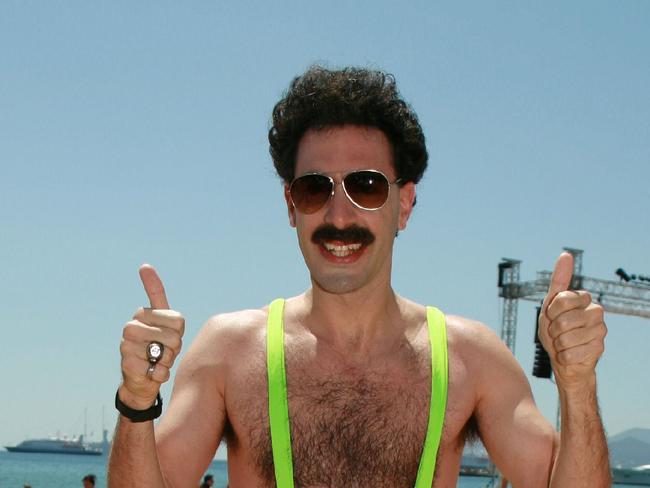 Actor Sacha Baron Cohen in scene from film 'Borat : Cultural Learnings of America for Make Benefit Glorious Nation of Kazakhstan'. f/l movies thumbs up beaches mankini ? beachwear