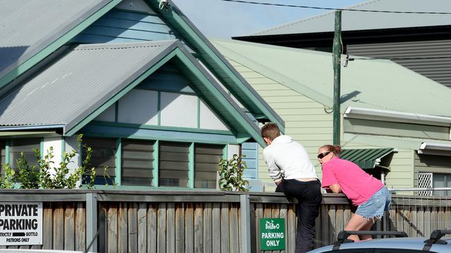 Friends of the victim who was shot in his house at Wickham, Newcastle, look over the scene where police investigate the murder. Picture by Peter Lorimer.