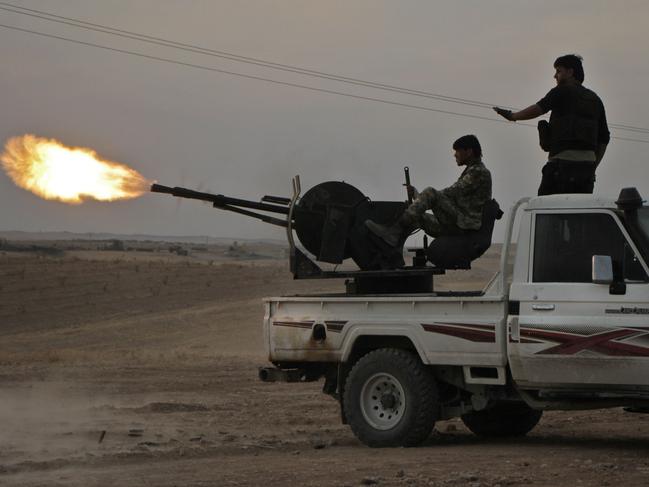 Turkish-backed Syrian fighters fire a truck mounted heavy gun near the town of Tukhar, north of Syria's northern city of Manbij. Picture: AFP