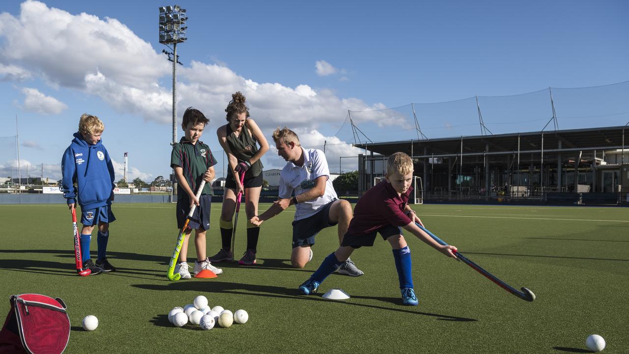 Junior player (right) Jaxom Gripske takes his shot as (back, from left) Eli McCurley Ault, Elliot Rollason and Kiana Gripske get advice from Toowoomba Hockey Association regional hockey and coaching manager Matt Cook in the lead up to the THA come-and-try day at Clyde Park, Wednesday, February 3, 2021. Picture: Kevin Farmer