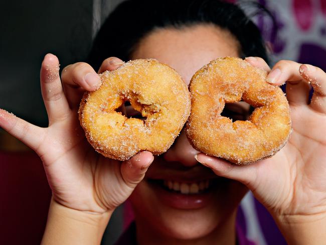 Fiona Sang prepares one of the last batches of cinnamon donuts which will be on sale 2 for 1 as the store prepares to close its doors at Casuarina Square.