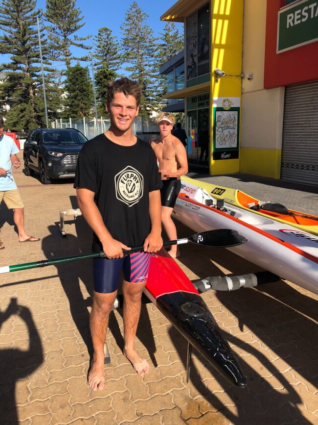 Jed Ffench next to his surf ski after paddling ashore. Picture: Dan Demaria