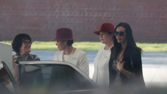 Megan Gale was seen wearing a dark coat and sunglasses as she got into a limousine after the service.