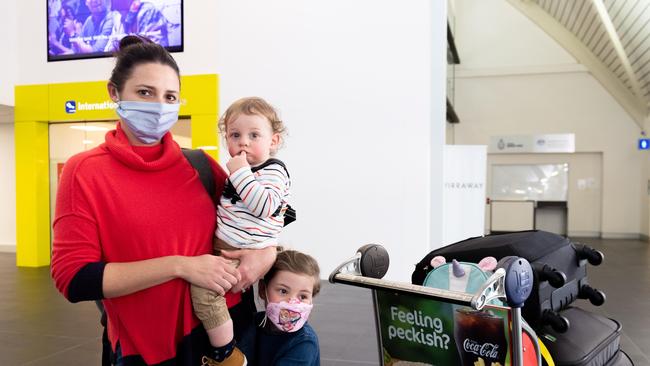 Brook and her children, aged 16 months and four years old, were among the passengers on board a flight from Sydney to Darwin yesterday, having scrambled to make it into the NT before the midnight cut-off for home quarantine ends for people arriving from hotspot areas. Picture: Che Chorley