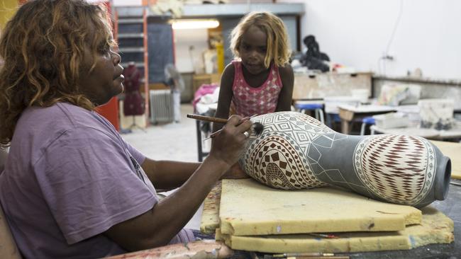 An artist at work at Ernabella Arts.