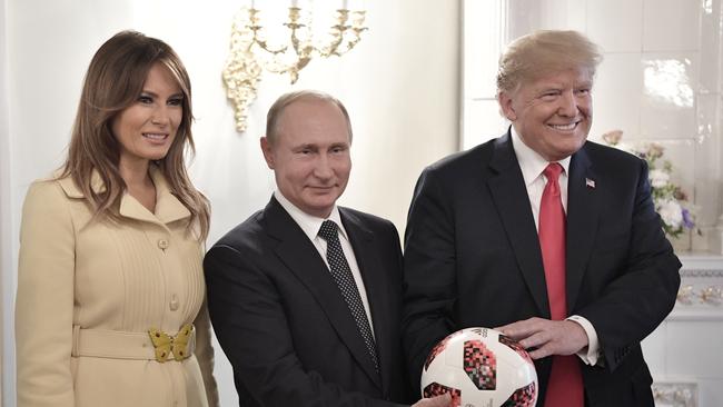 U.S. First Lady Melania Trump, left, Russian President Vladimir Putin, center, and U.S. President Donald Trump, pose with a soccer ball after a press conference following their meeting at the Presidential Palace in Helsinki, Finland, Monday, July 16, 2018. (Alexei Nikolsky, Sputnik, Kremlin Pool Photo via AP)