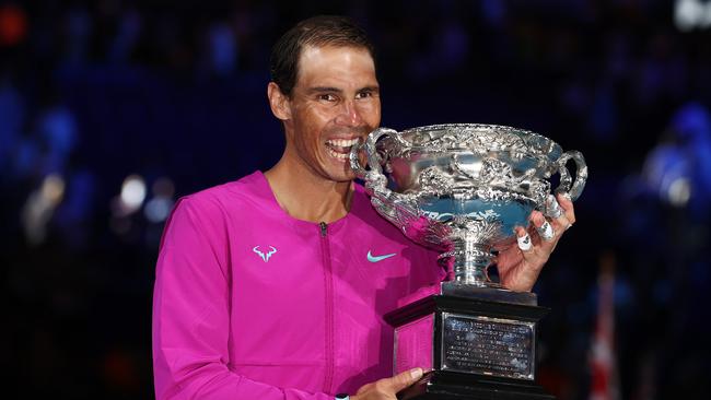 Rafael Nadal with the winners trophy at Rod Laver Arena, which is for sale. Photo by Michael Klein