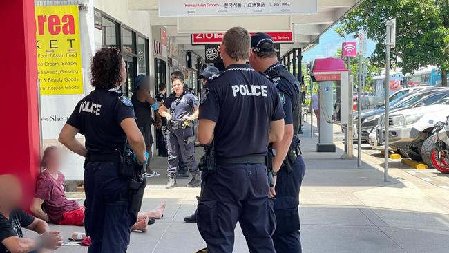 Nine police officers handcuffed four men during an unrelated incident on Lake Street in the Cairns CBD in March.