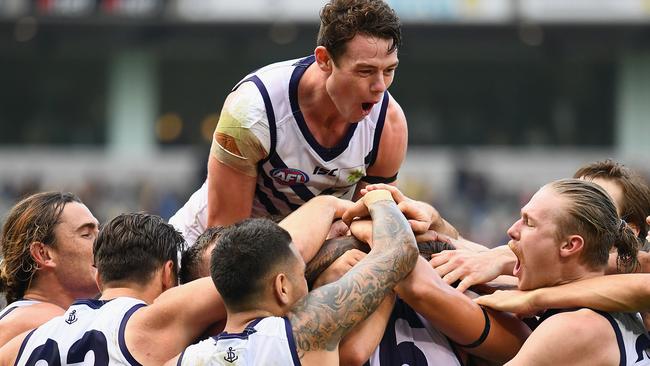 ANOTHER THRILLER: Fremantle’s Lachie Neale celebrates with teammates after his side’s after-the-siren two-point win against Richmond in Round 8. Picture: Quinn Rooney (Getty Images).