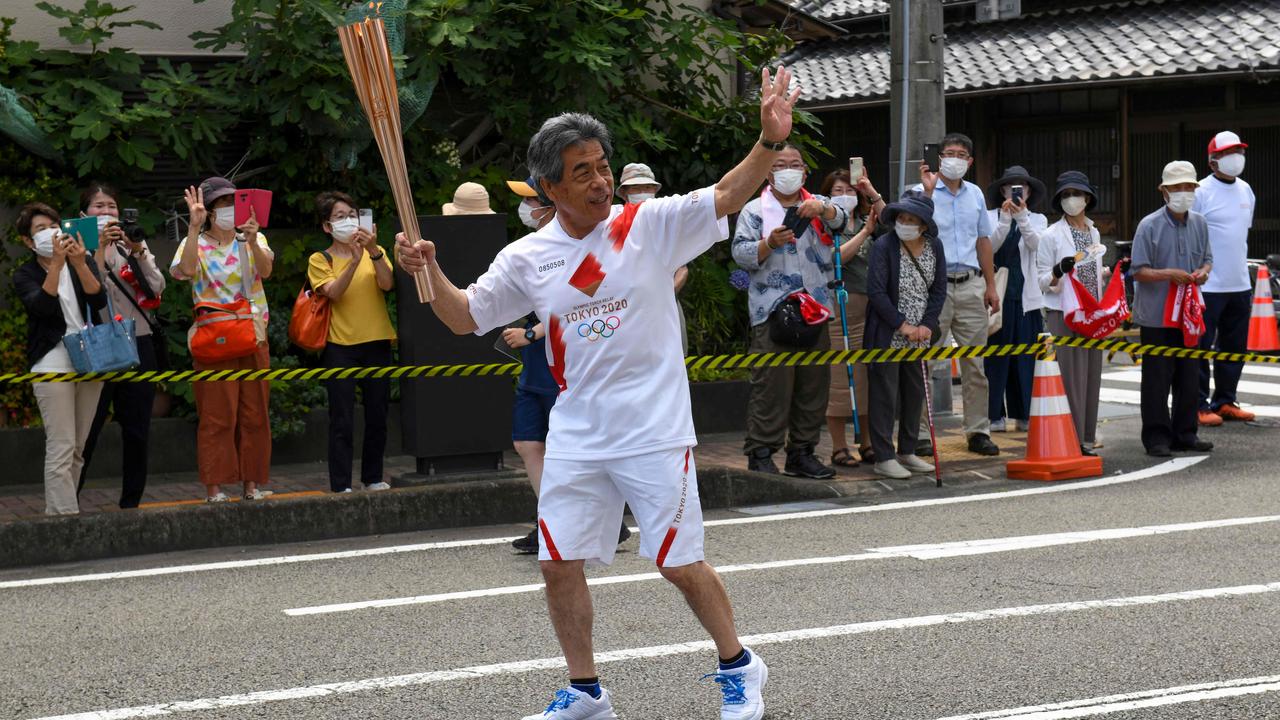 A torchbearer runs with the Olympic torch during the Tokyo 2020 Olympic Games torch relay in Yaizu, Shizuoka prefecture on June 24, 2021. Picture: AFP