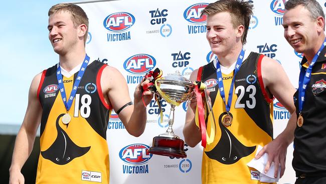 Co-captains Mitchell Riordan (L) and Campbell Hustwaite with coach Craig Black and the premiership cup.