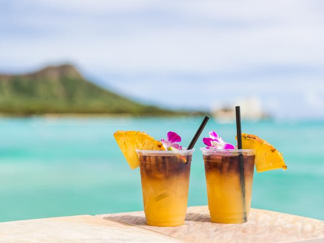 Hawaii mai tai drinks on waikiki beach bar travel vacation in Honolulu, Hawaii. Photo - istockESCAPE 13 March 2022