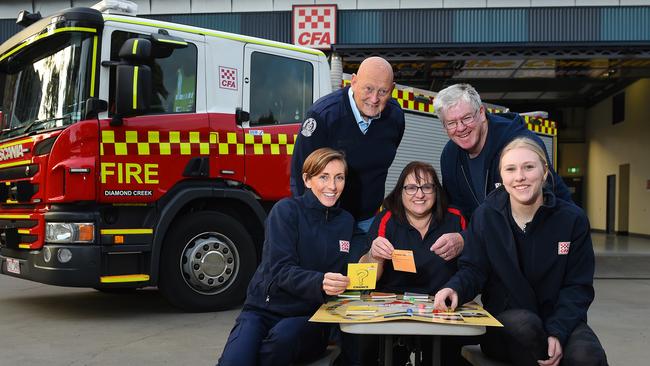 Diamond Creek CFA members Fiona Macken, Hugh Pilsworth, Antoinette Ribchester, Bill Pritchard and Kellie Clarkson enjoy The Fire Game, designed to educate families about the bushfire season. Picture: Josie Hayden