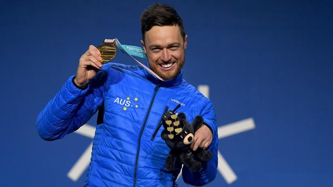 Australian snowboarder Simon Patmore celebrates with his gold medal.