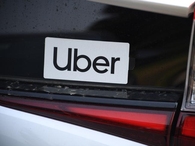 In this file photo taken on August 20, 2020 an Uber sticker is seen on a car at the start of a protest by ride share drivers in Los Angeles, California. (Photo by Robyn Beck / AFP)