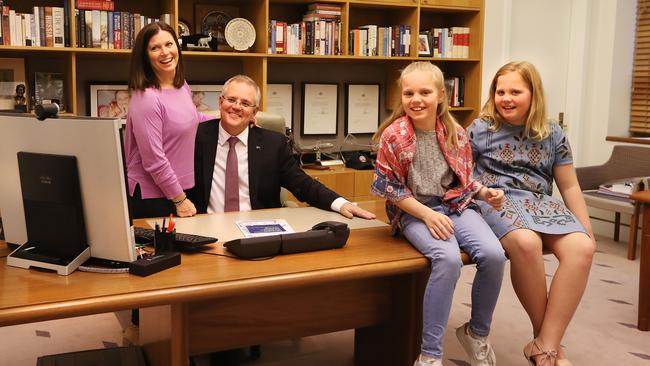 PM Scott Morrison in his old Treasurer’s office at Parliament House in Canberra with his wife Jenny and daughters Abbey and Lily. (Pic: Kym Smith)