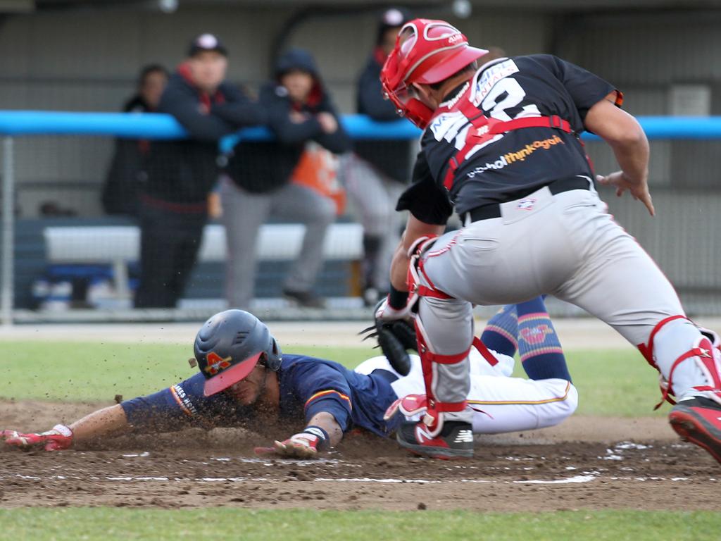 American shortstop Mikey Reynolds dives to score Adelaide Bite’s first run of its home clash with Perth Heat. Picture: Dean Martin/AAP