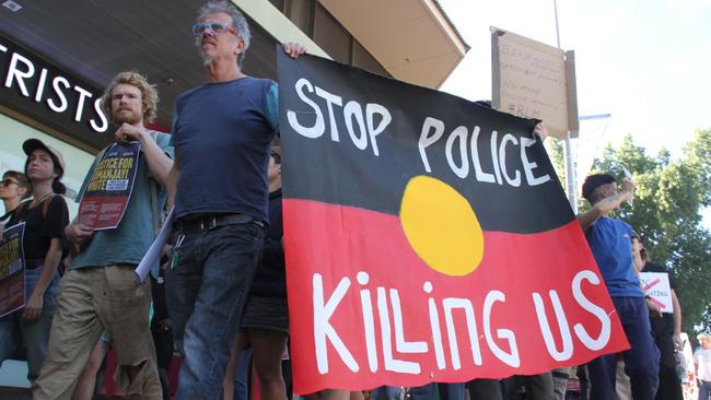 Marchers head down Hartley St, Alice Springs, once the courthouse lawns rally concluded. Picture: Gera Kazakov