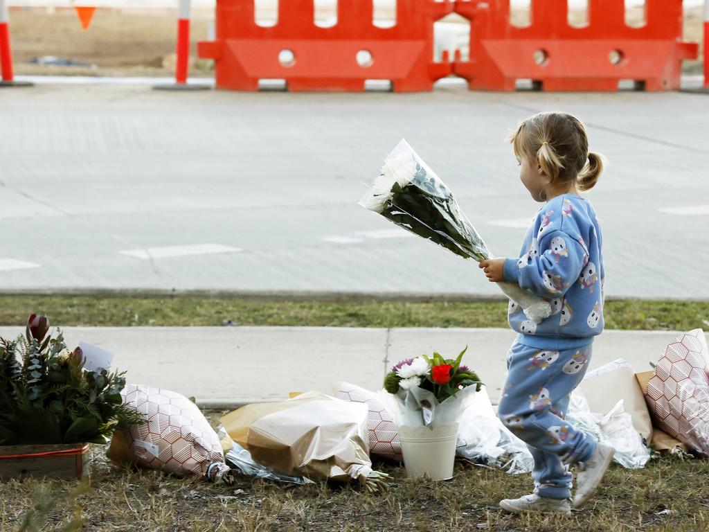 Parents came with children to leave flowers on Tuesday. Picture: Jonathan Ng